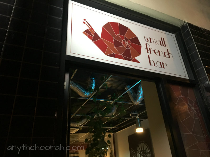 small french bar with amazing geometric snail logo in Footscray