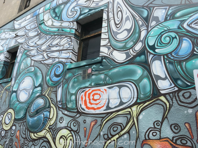 interesting grey and blue and orange street art graffiti in collingwood