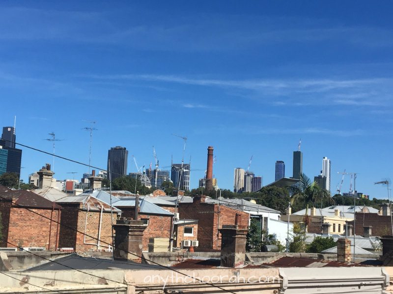 view over rooftops towards melbourne city