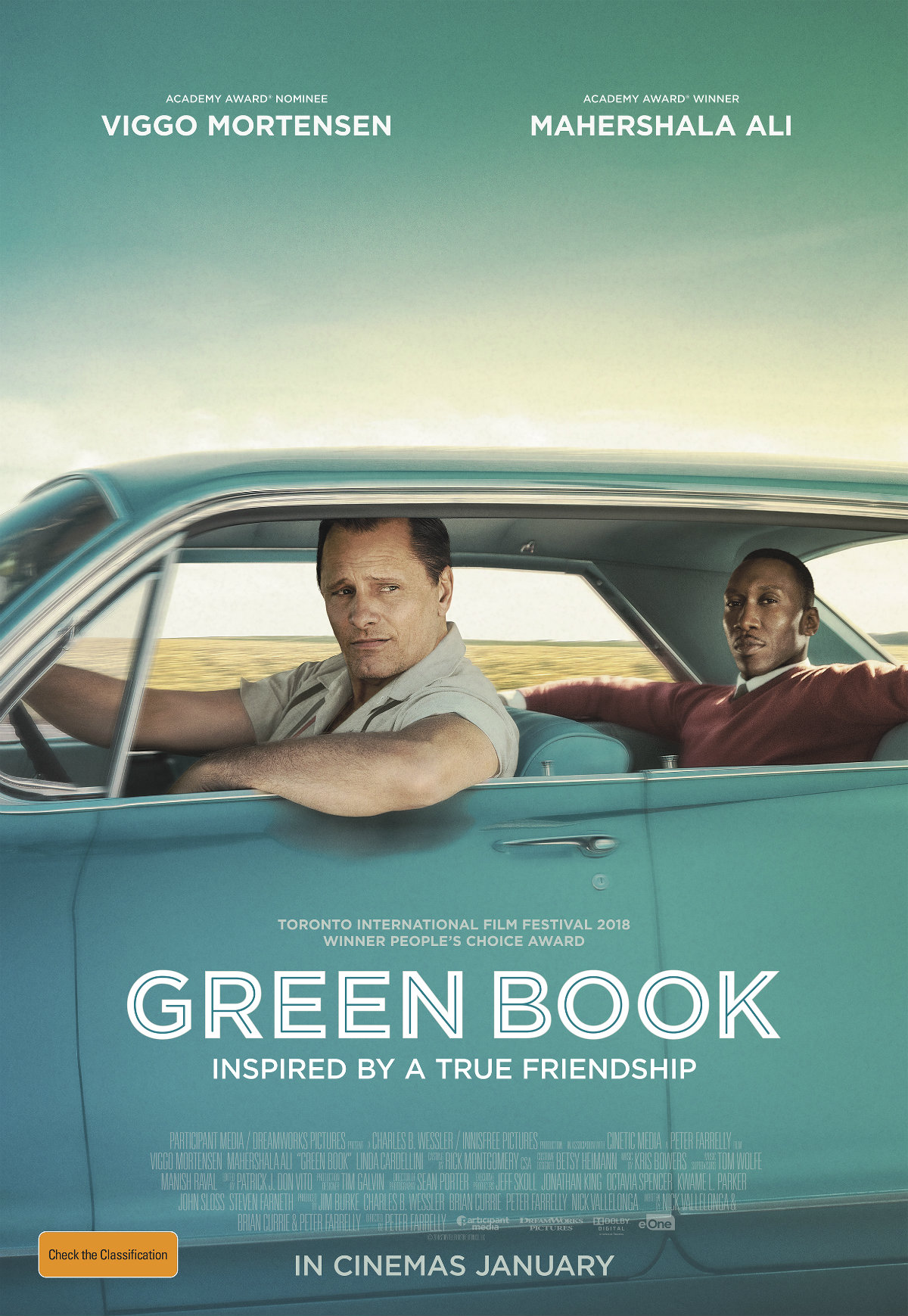 Green Book - a story of true friendship - tony and don in a blue green cadillac driving through the usa