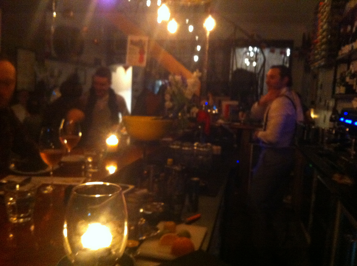 sebastien working the bar at bon ap with dappled lights and blurry focus