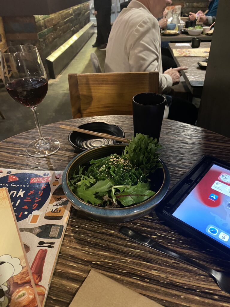 seaweed salad and glass of pinot noir at Gyoza Gyoza in Melbourne CBD - Little Bourke Street